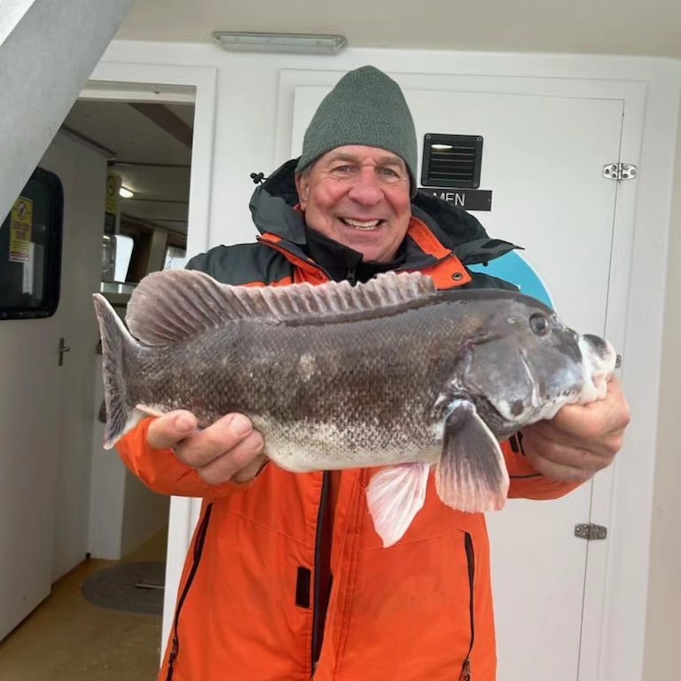 a man holding a fish